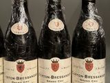 six bottles of wine are lined up on a table