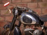 a motorcycle that is parked in front of a brick wall