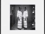 framed black and white photograph of two women in traditional clothing