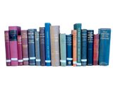 many books that are lined up together on a shelf