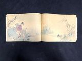 an open book with a picture of a woman in a kimono