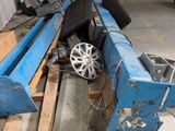 une machine bleue posée sur une palette dans un garage
