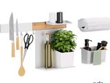 a white shelf with a knife, cutting board, and a potted plant on it