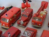 a lot of toy fire trucks and cars on the table