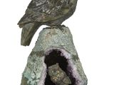 une statue représentant un hibou perché sur un rocher