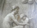 a statue of a woman holding a baby in her lap