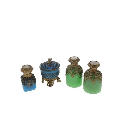 three small glass bottles sitting next to each other on a white surface