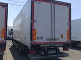 two trucks that are parked next to each other on the street