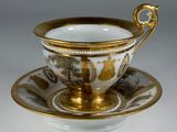an image of a cup and saucer with a gold rim