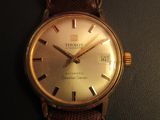 a close up of a wrist watch on a black surface