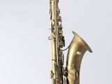 an old brass saxophone on a stand against a white background