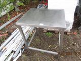 a metal table that is sitting on the ground