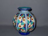 a blue and white vase with a flower design on it