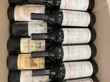 many bottles of wine in a box on the table