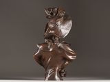 bronze statue of a woman with a hat on her head and a flower in her hair