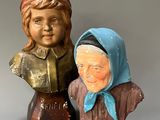 two figurines of a woman and a man on a table