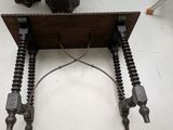 a wooden table with two legs that are connected to a wire