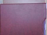 two folders sitting on top of each other on a table