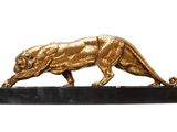 statue of a golden lion on a black marble base