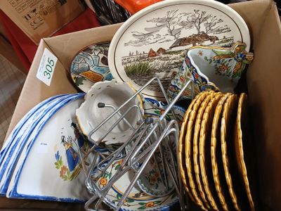 a box full of plates and bowls with a wire rack