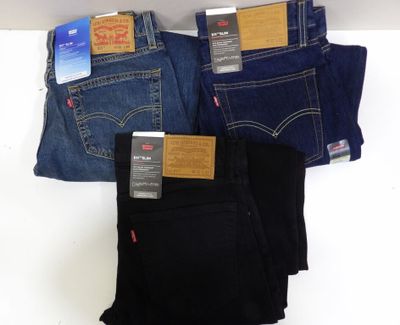 three pairs of levi ' s jeans are stacked on top of each other