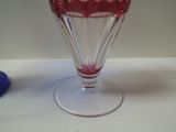 a glass vase with a red liquid inside of it