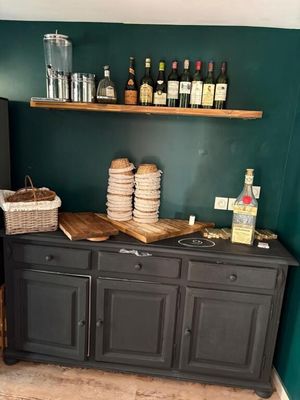 a small kitchen with a black refrigerator and a wooden counter