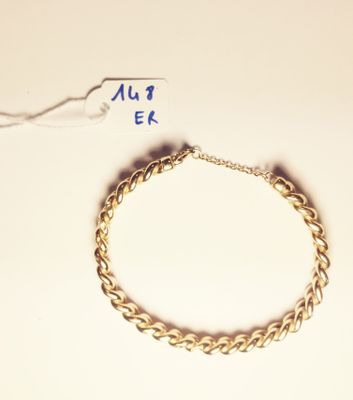 a gold bracelet with a chain attached to it