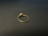 a close up of a gold ring on a black surface