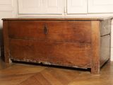 a wooden chest sitting on the floor in a room
