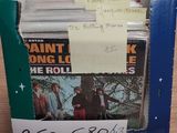 a cardboard box with a bunch of records in it