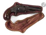 an old revolver with a leather case on a white background