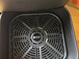 a person taking a picture of the inside of a dishwasher