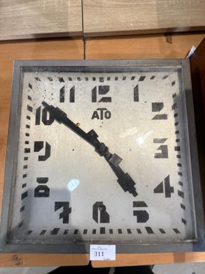 a clock that is sitting on a shelf in a room