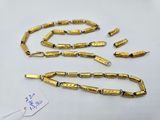 a close up of a gold chain with a tag on it