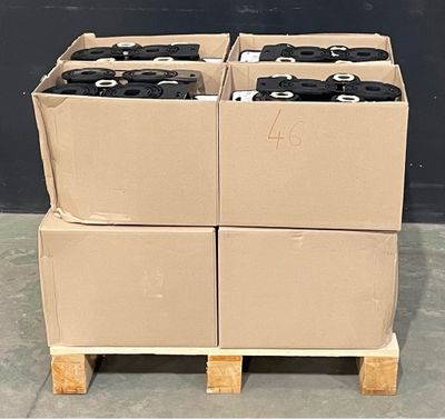 four boxes of tires stacked on a pallet in a warehouse