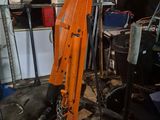 an orange machine that is sitting in a garage