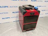 a red and black amplifier sitting on top of a white table