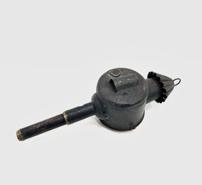 a small black object that is sitting on a white surface