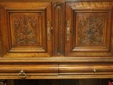 a large wooden cabinet with carvings on the doors