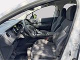 the interior of a car with the door open and the driver ' s seat down