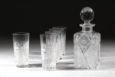 quatre verres et une carafe posés sur une table