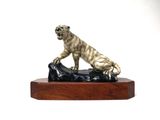 statue of a tiger on a rock on a wooden base