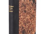 an old book with a black cover and gold trim