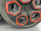 a close up of a tire with red and black spokes