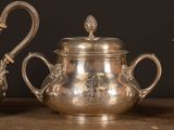three silver teapots sitting on a table next to each other