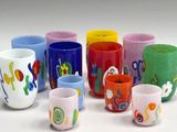 many different colored cups that are lined up together