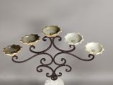 wrought iron candelab with five oysters on it