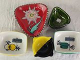 four small dishes with different designs on them on a table