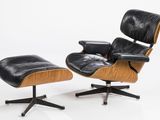 a black leather lounge chair and ottoman on a white background